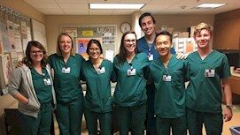 A group of seven people in green scrubs, representing EPPA Health, stand smiling in a Minnesota hospital setting.